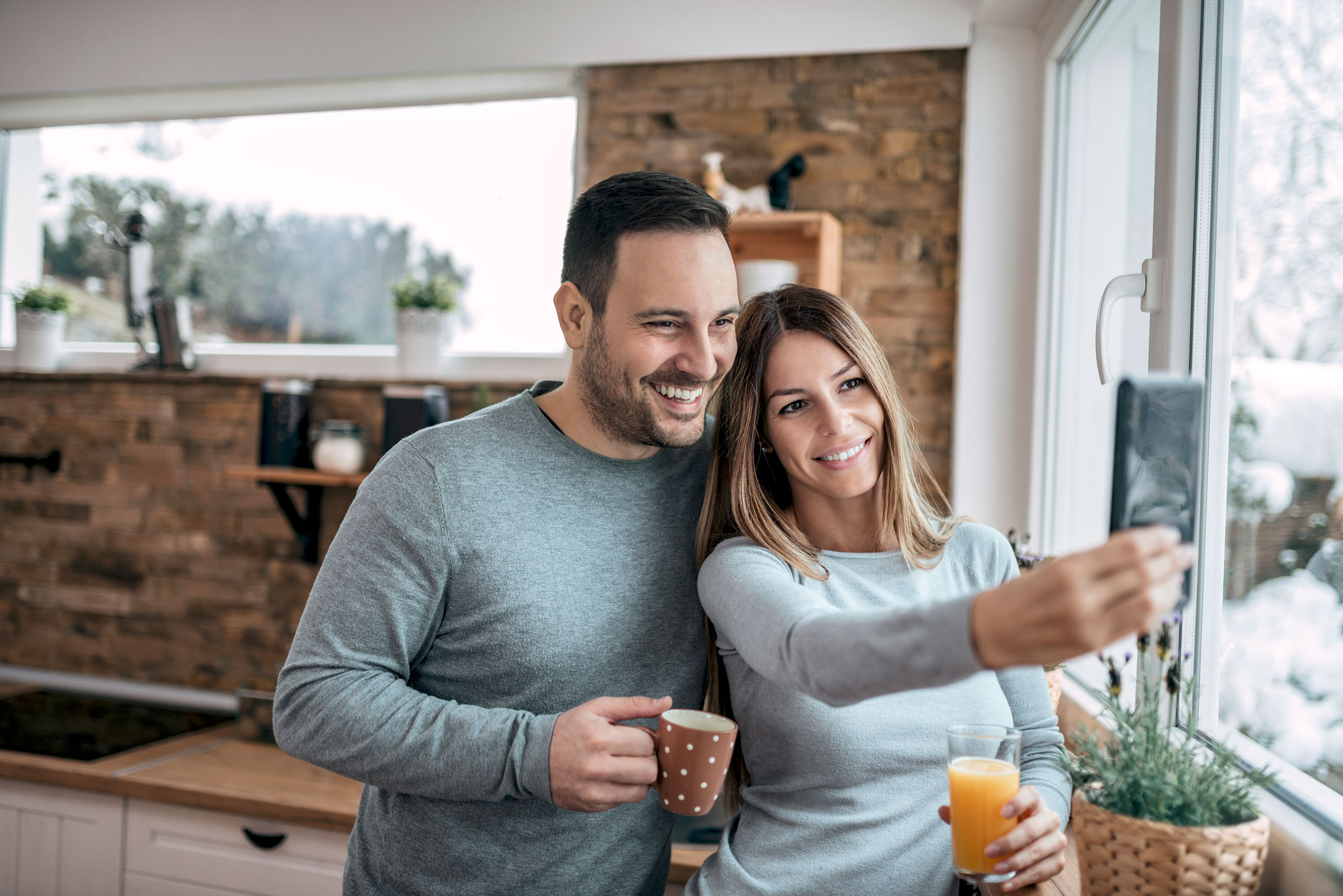 Junges Paar in der Wohnung macht ein Selfie